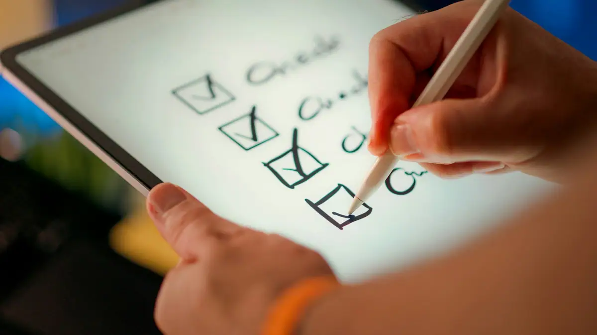 Hand checking off items on a digital checklist