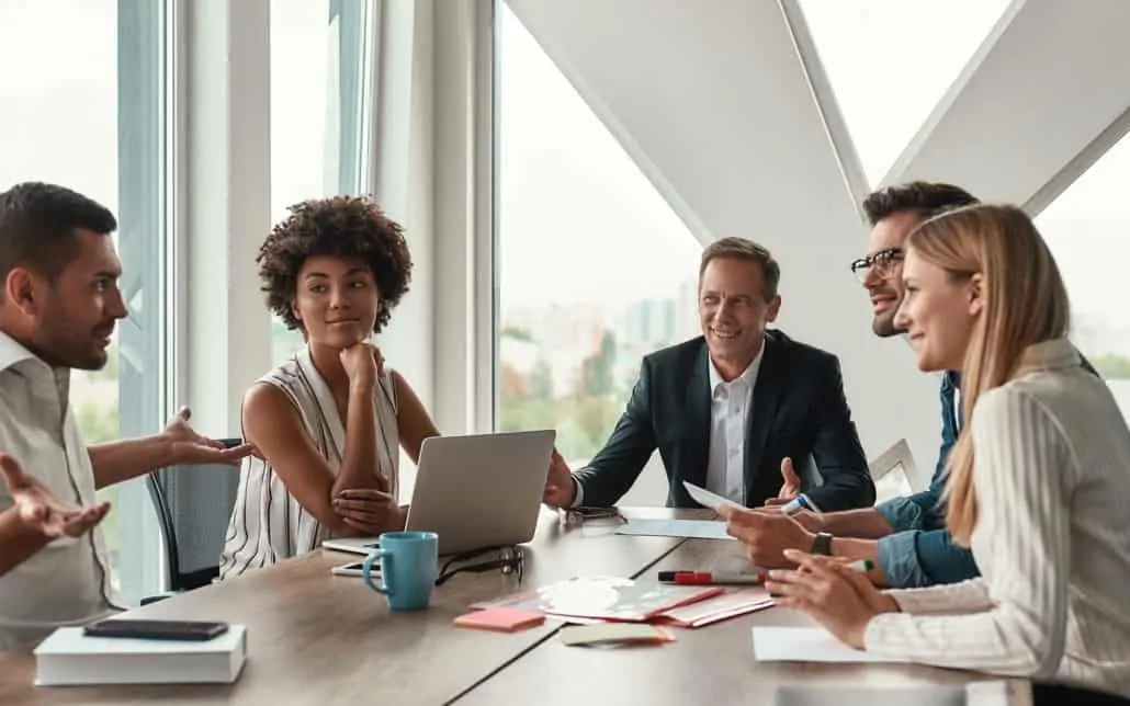 business professionals sitting in a conference room having a meeting