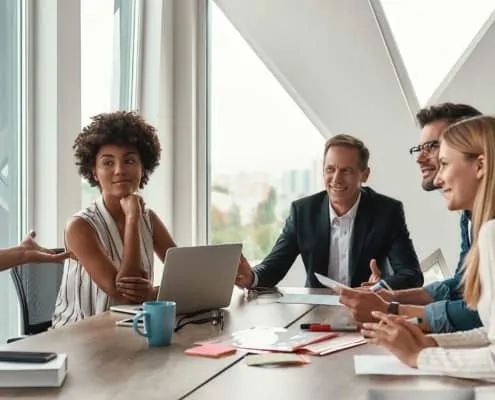 business professionals sitting in a conference room having a meeting