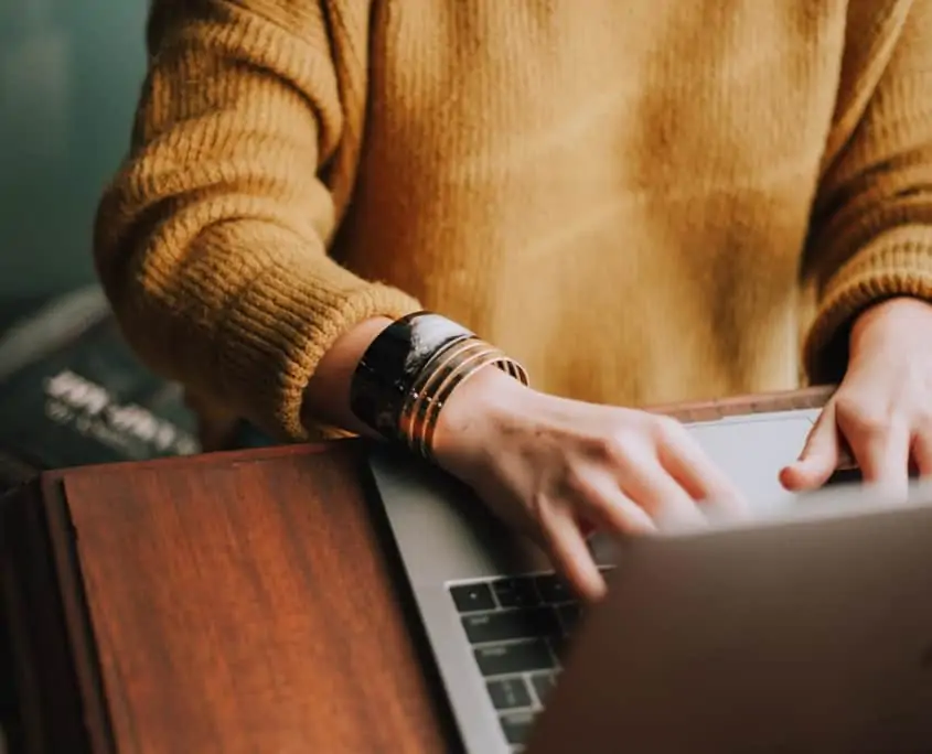 Close up view of woman working on a laptop