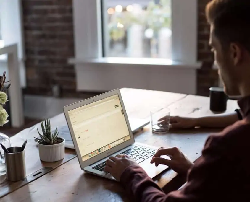 Man sitting at desk working on a laptop