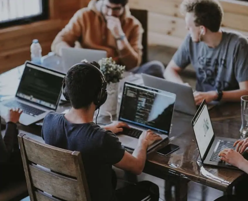 Overhead view of a group of people working on laptops